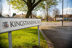 Street sign for Kingstanding Road in Birmingham with surrounding houses and local shops, showing the context for Lapworth Architects’ residential scheme at 623 Kingstanding Road.